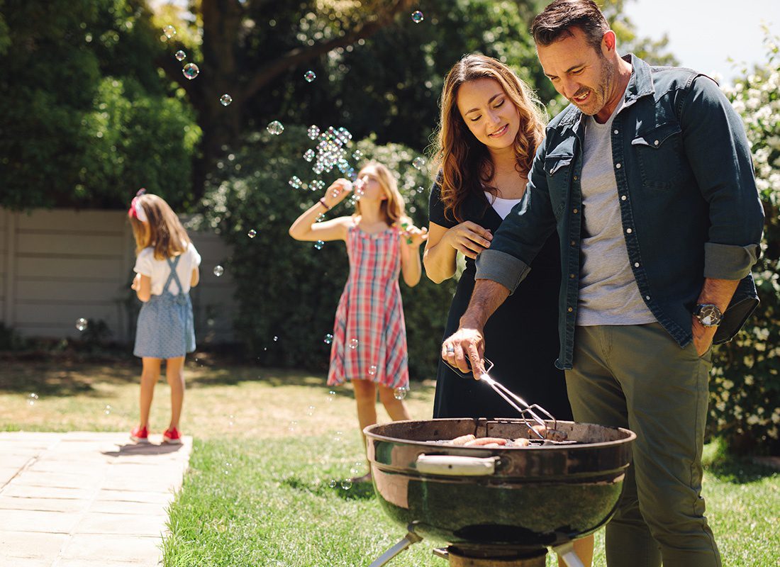 Personal Insurance - Family and Daughters Enjoying a Nice Sunny Day and Grilling